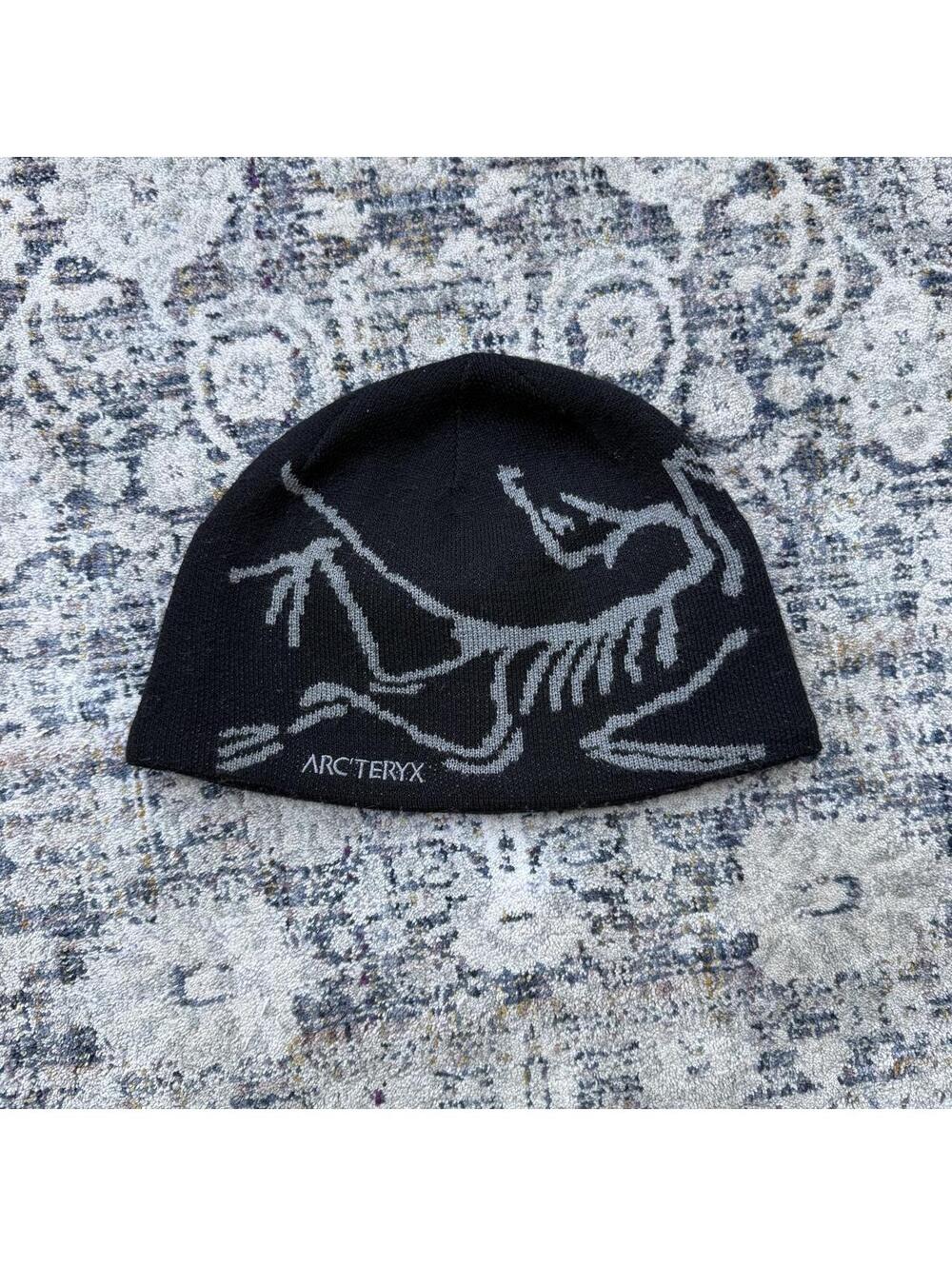 Arc'teryx black beanie with gray dinosaur skeleton graphic #outdoor #hiking